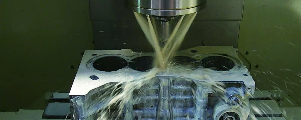 a CNC machine cutting a piece of metal.