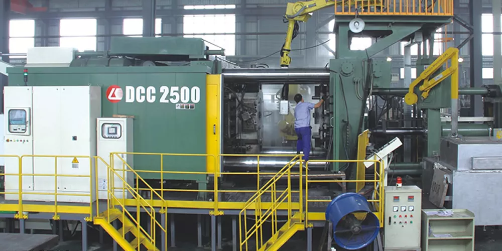 Workers operate FANUC's ROBODRILL-1600X CNC machine